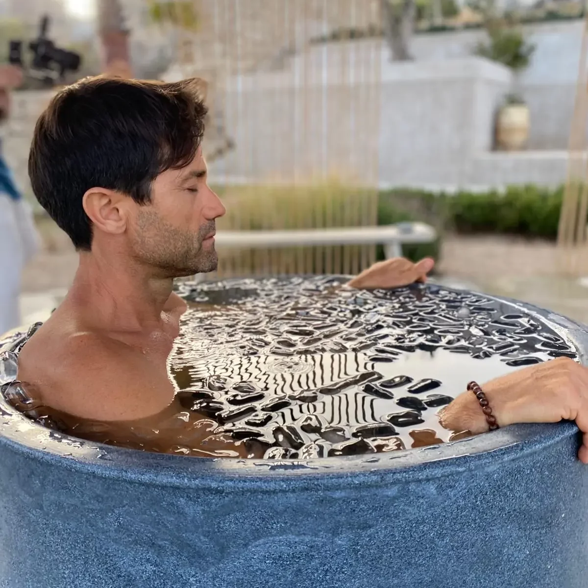 Guest immersed in an outdoor cold-water ice bath
